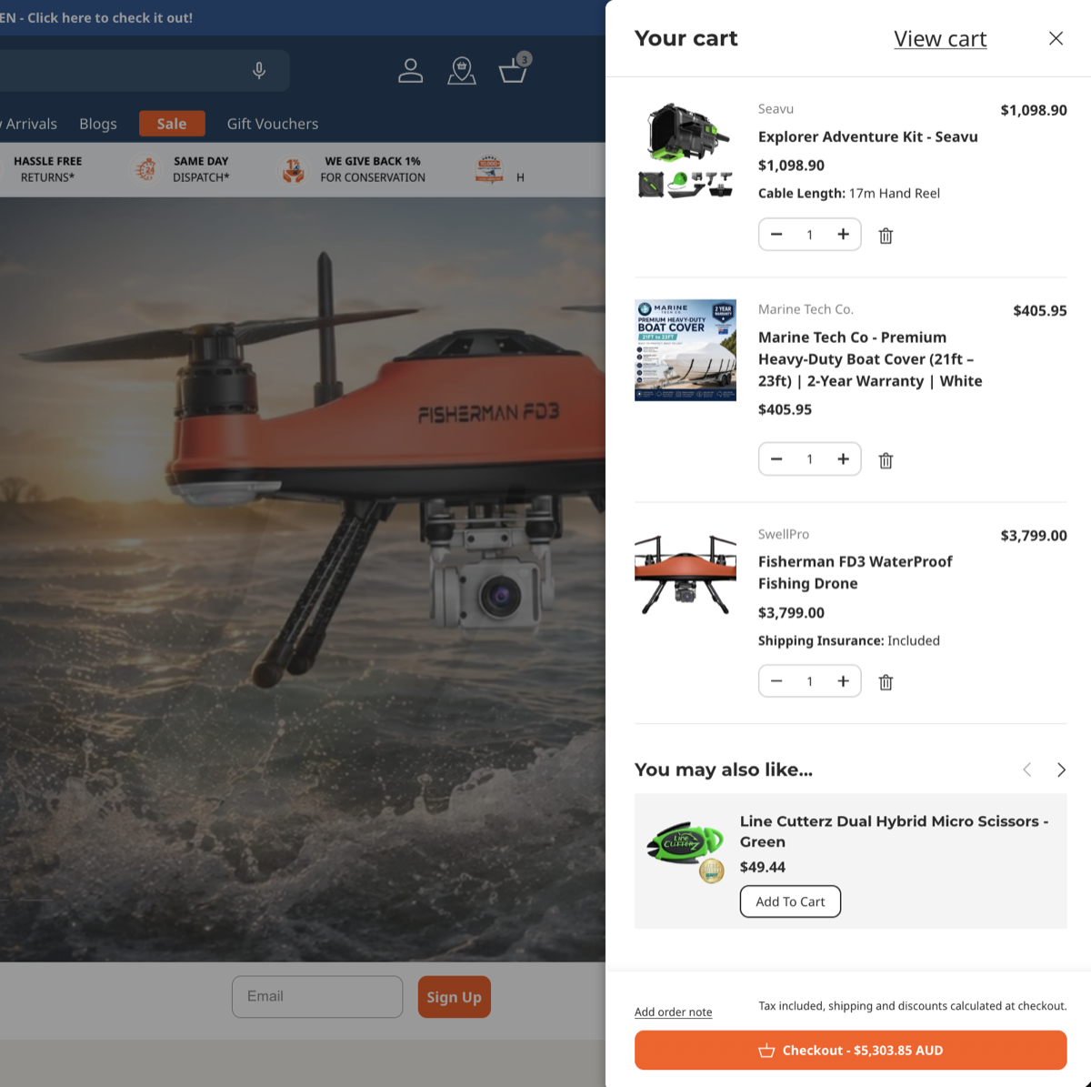 Fishing Superstore slide-out cart showing line items, quantity steppers, cross-sell suggestions and a running order total